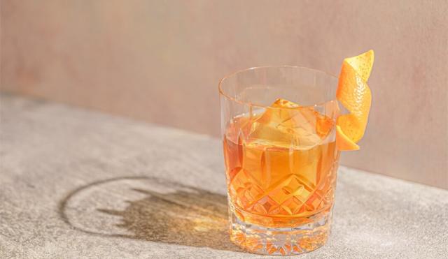 Waterford crystal whisky glass with orange cocktail